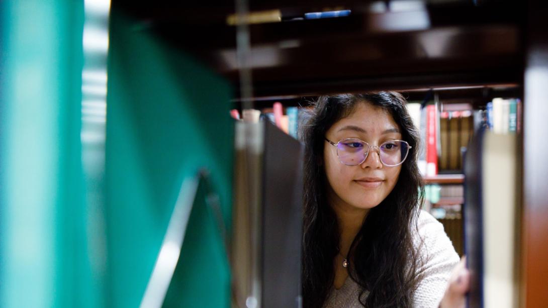 Girl in the library stacks