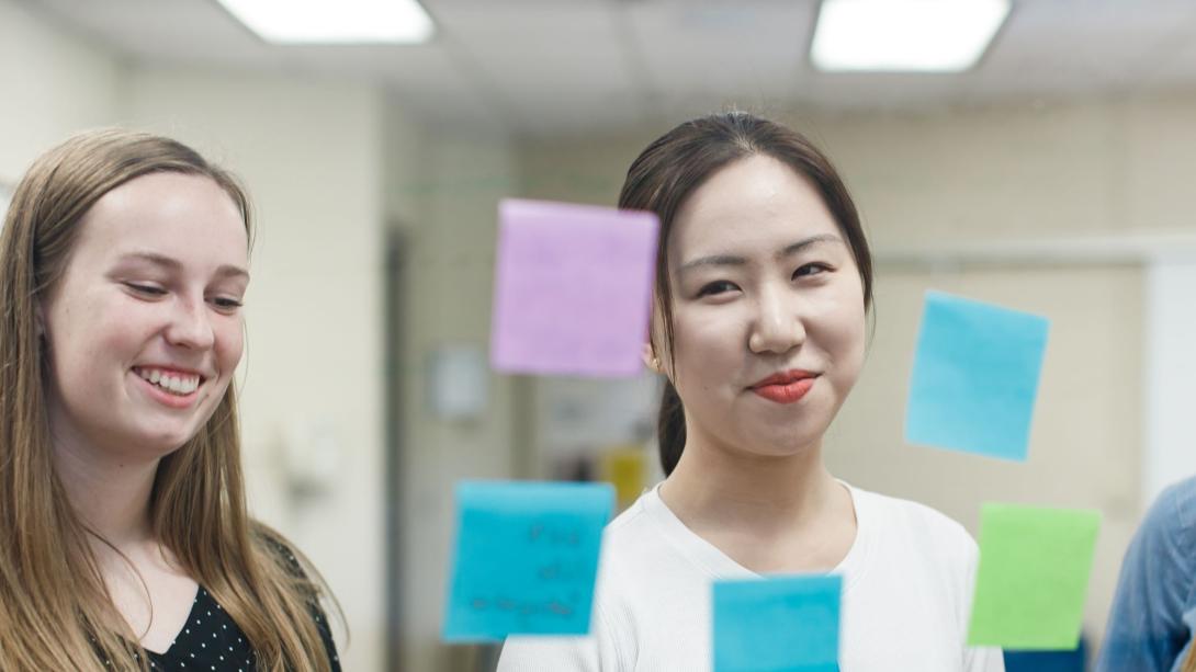 Two students working with sticky notes