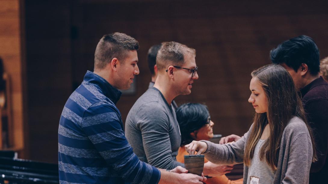 Three people taking communion