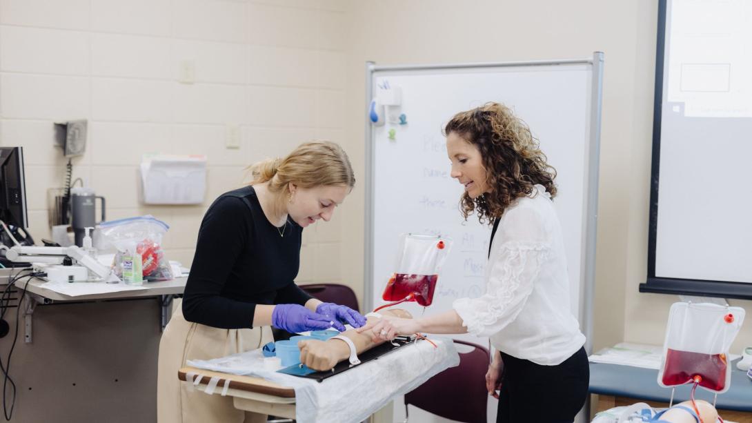 A nursing student learning from an intructor