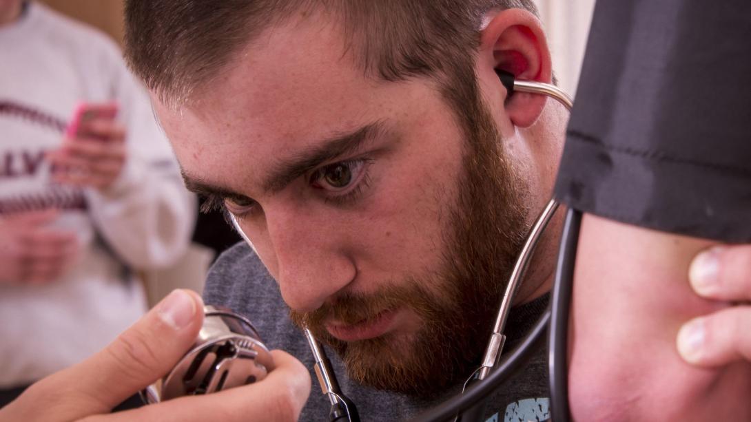 Student helping a patient