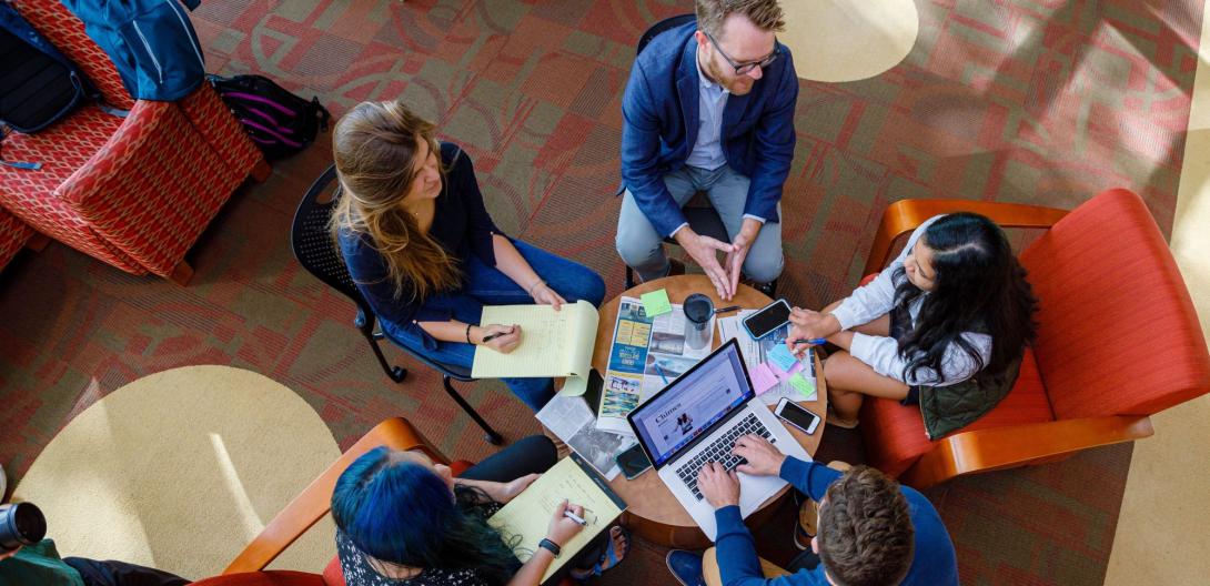 Group of students gathered around a table