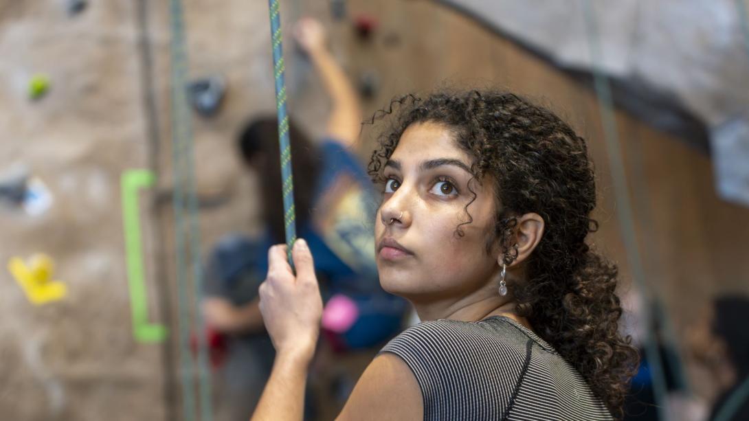 Woman climbing on a climbing wall