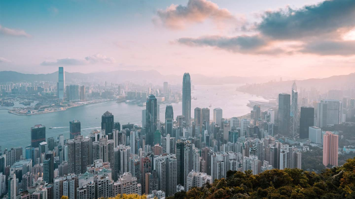Drone shot of Hong Kong city skyscrapers and river.