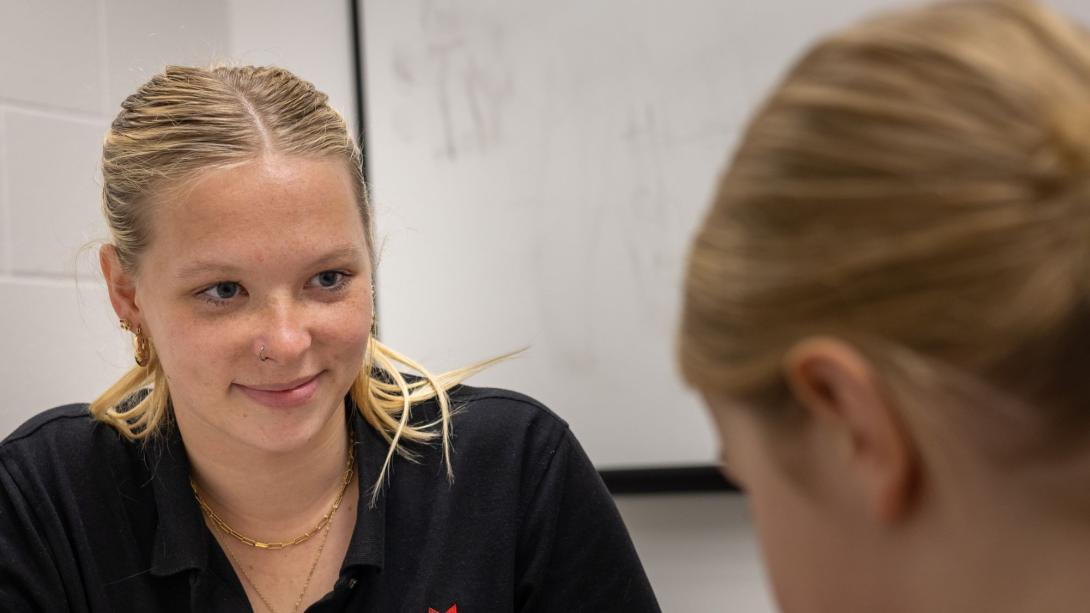 Student speech pathologist working with a young girl