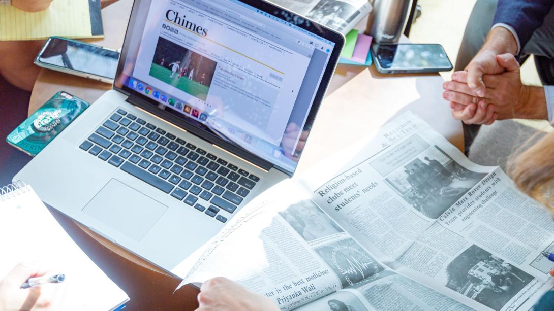 A laptop and student newspaper