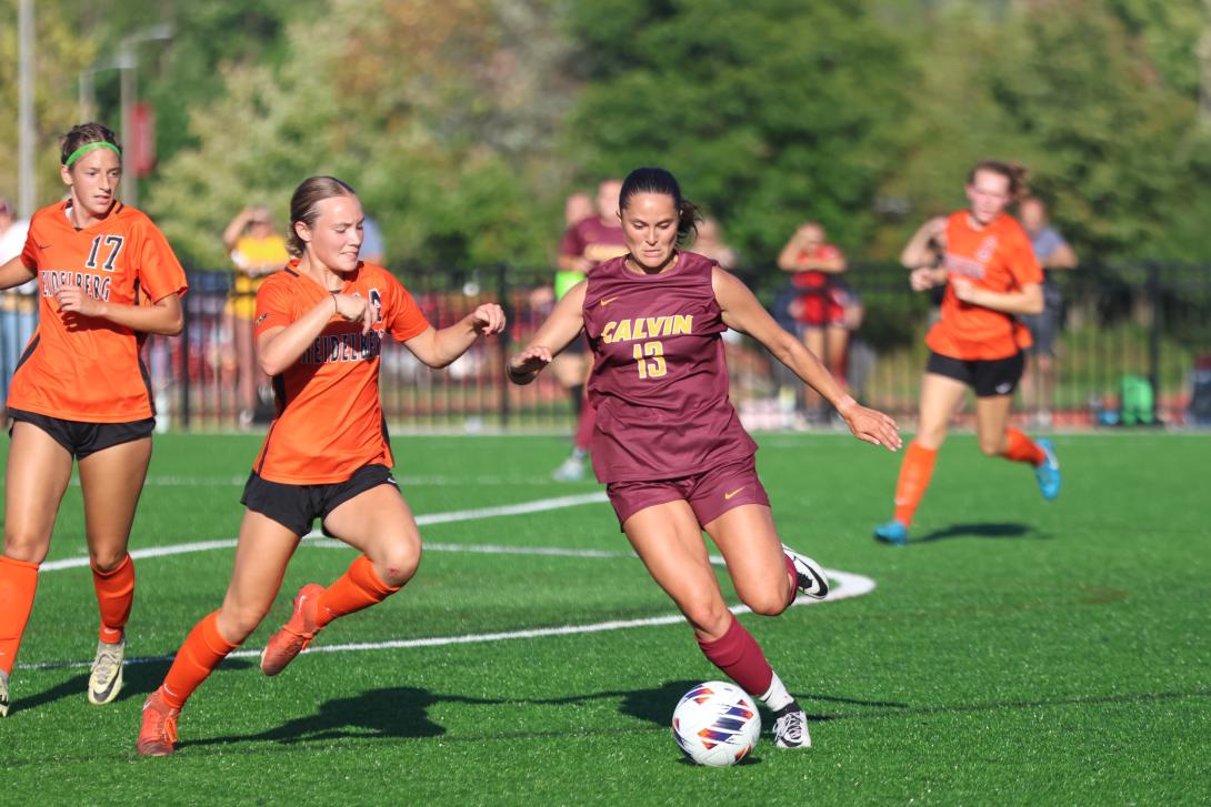 Calvin University women's soccer player about to kick the soccer ball