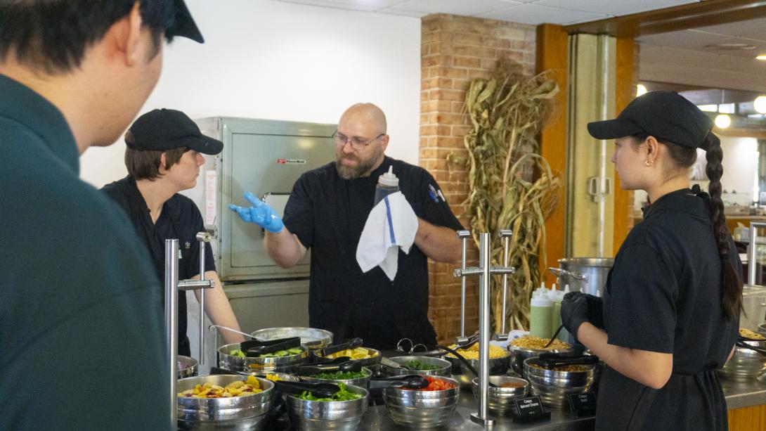 Chef Ryan Hartman speaks with a group of students at Globe Exhibition Bar.