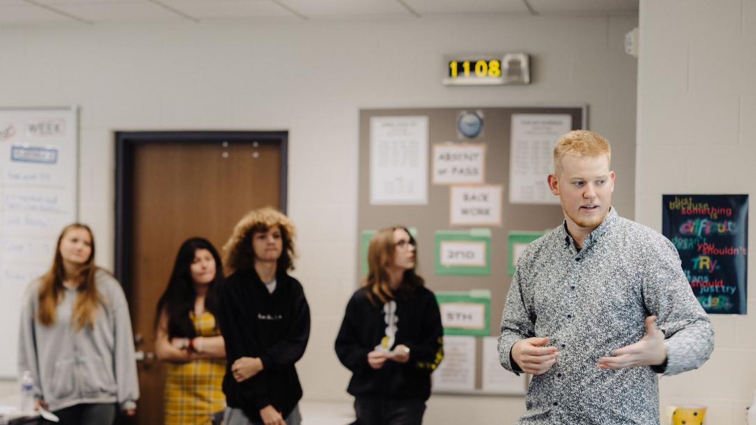 A teacher with several high school students