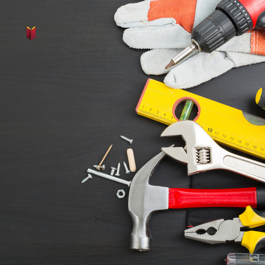 Construction tools laid out on a black table - Hekman Library logo in the corner