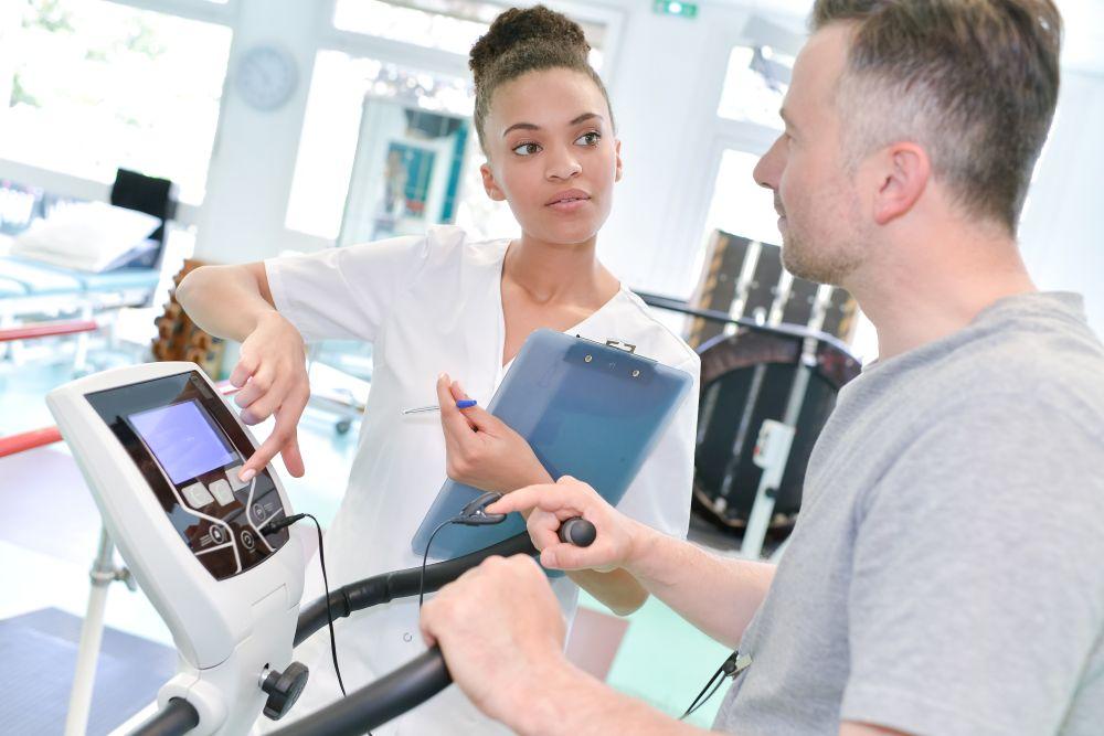 Woman helping a man with physical therapy