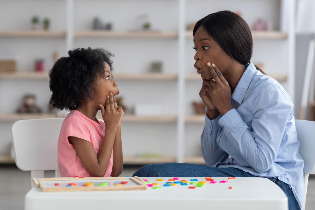 Woman doing speech therapy with a child