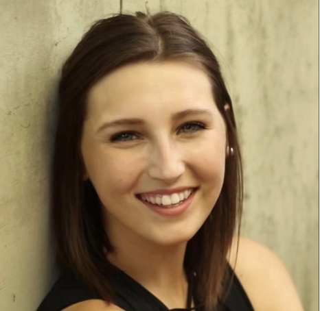 headshot of Michaela Stenerson, a white female with brown hair, smiling.
