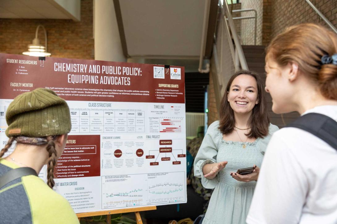 A STEM student presents her research poster titled, Chemistry and Public Policy: Equipping Advocates.
