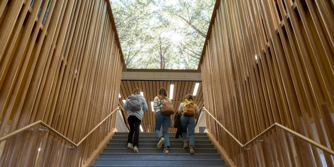 Students walking up a staircase at Calvin University.