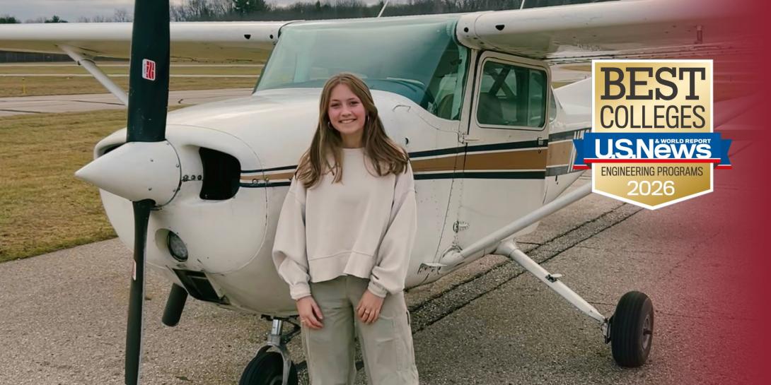 Ava Ibrahim, an aerospace engineering student at Calvin University, standing in front of a small airplane.