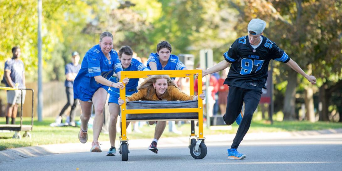 Students participate in bed races during Homecoming and Family Weekend on Calvin's campus.