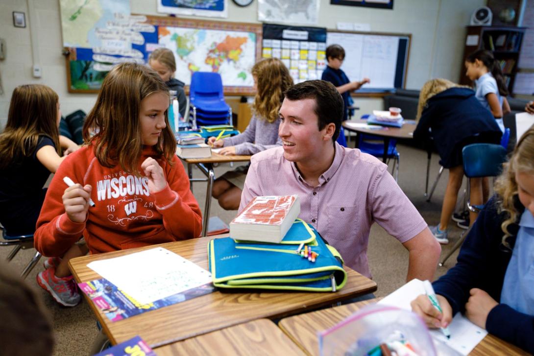 A teacher working with a grade school student