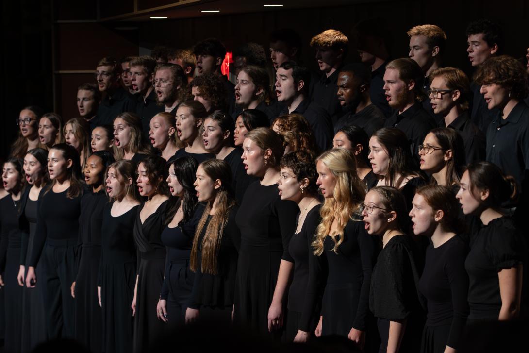 Capella choral ensemble singing on stage.