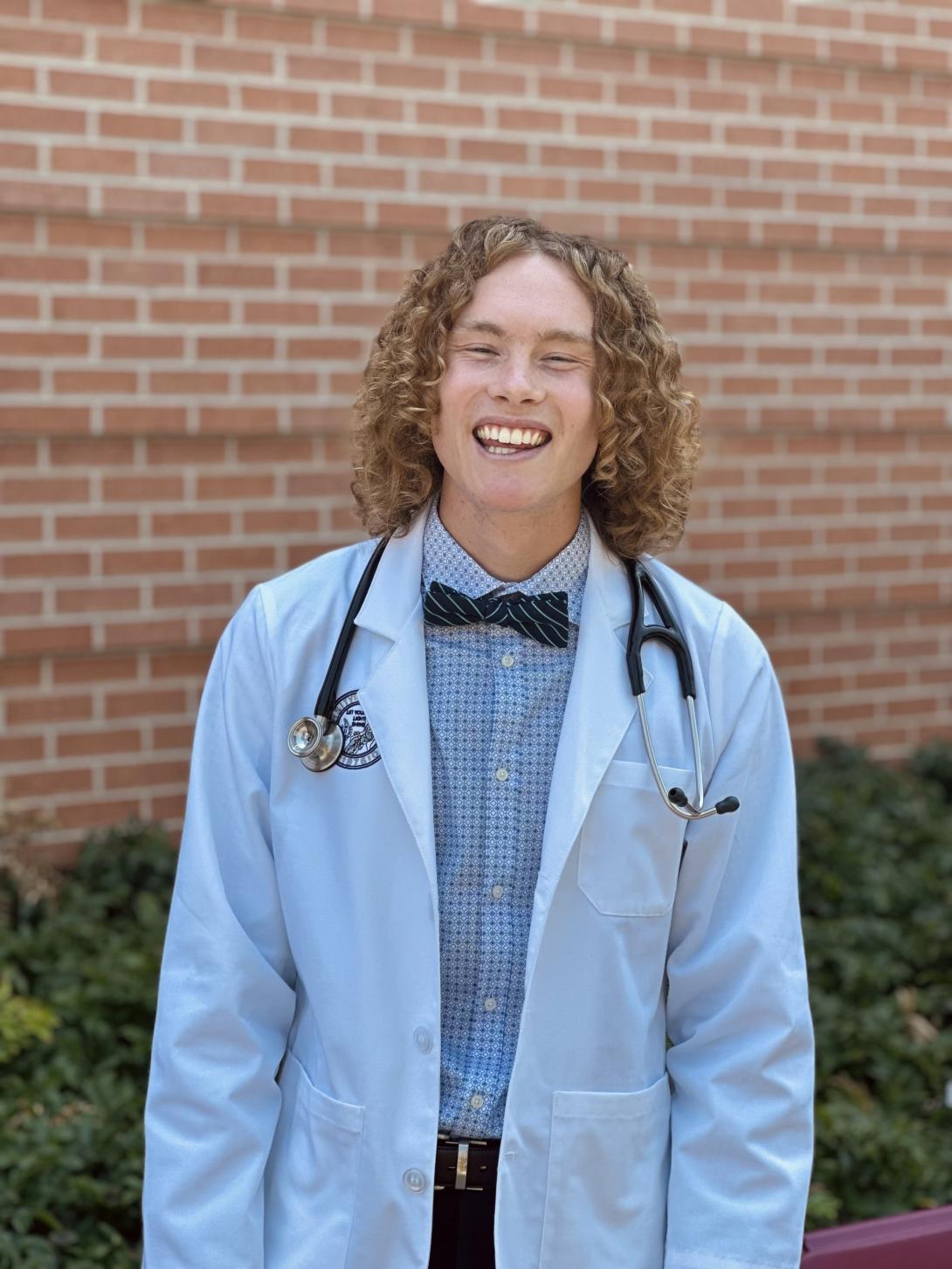 Photo of Jesse McCurdy. He has long curly hair and is a white male. 