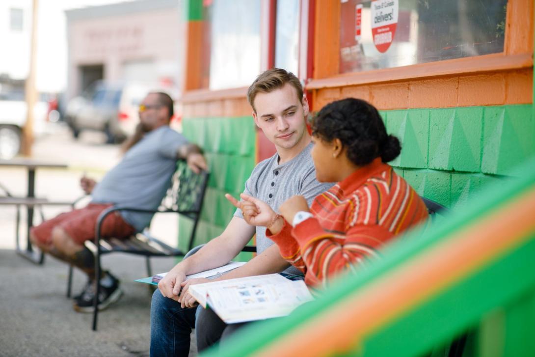 Two students seated at a bench