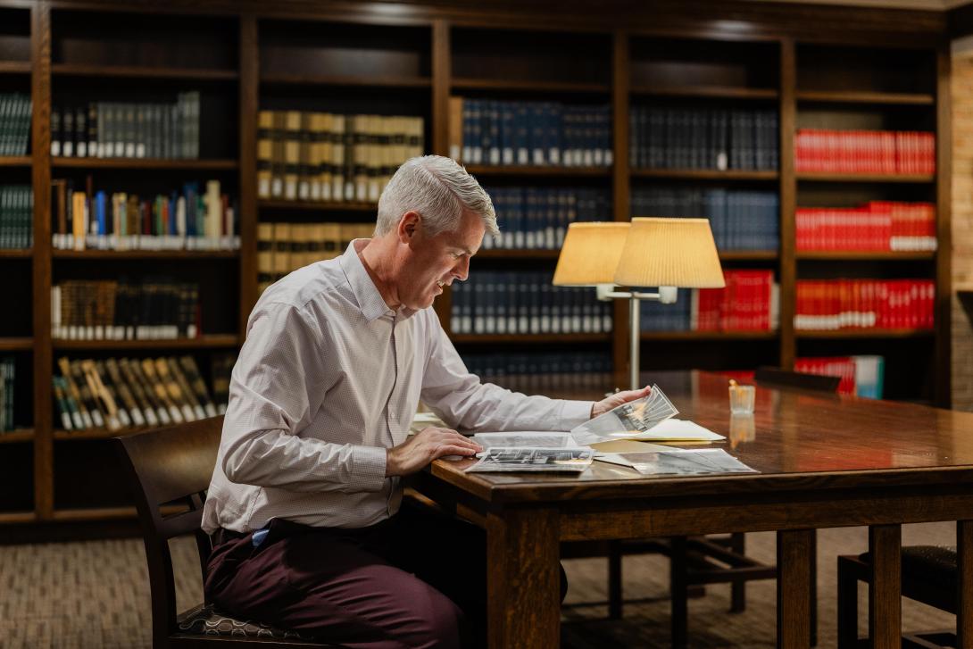 Jeff Haverdink reading publication in Heritage Hall at Calvin University