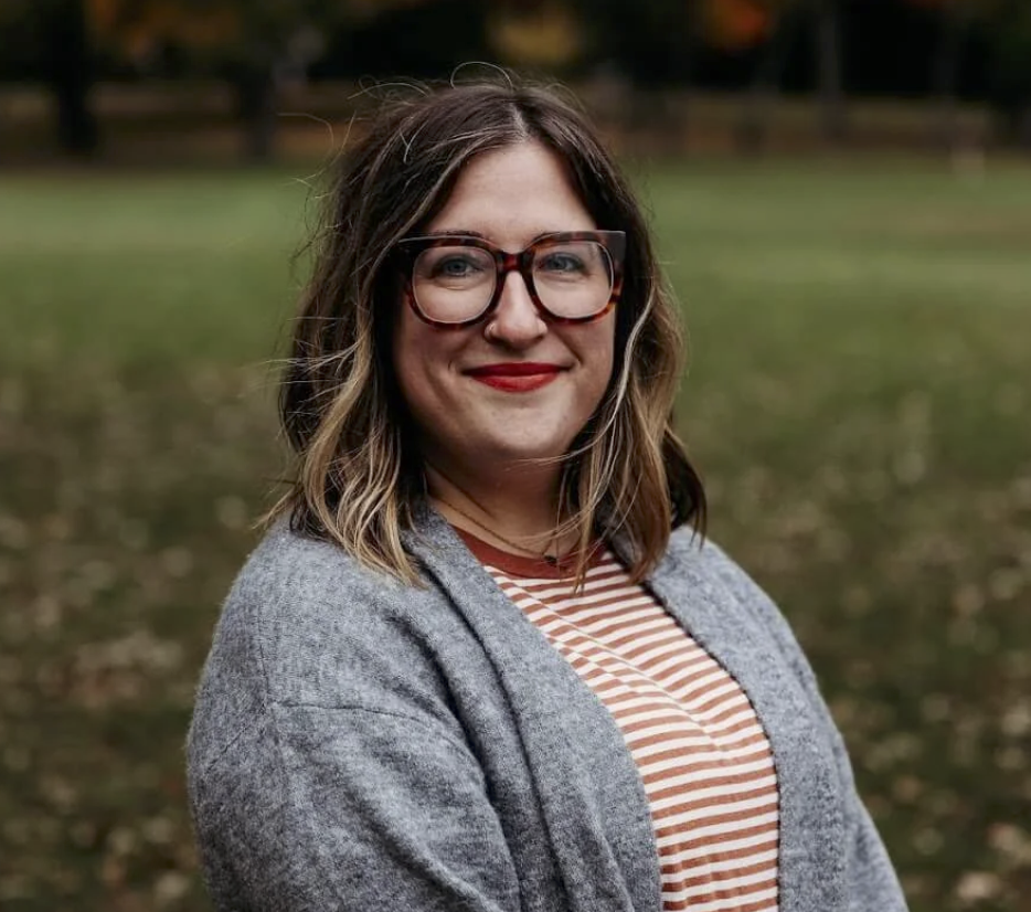 Photo of Lauren Cooper, smiling in front of grass background