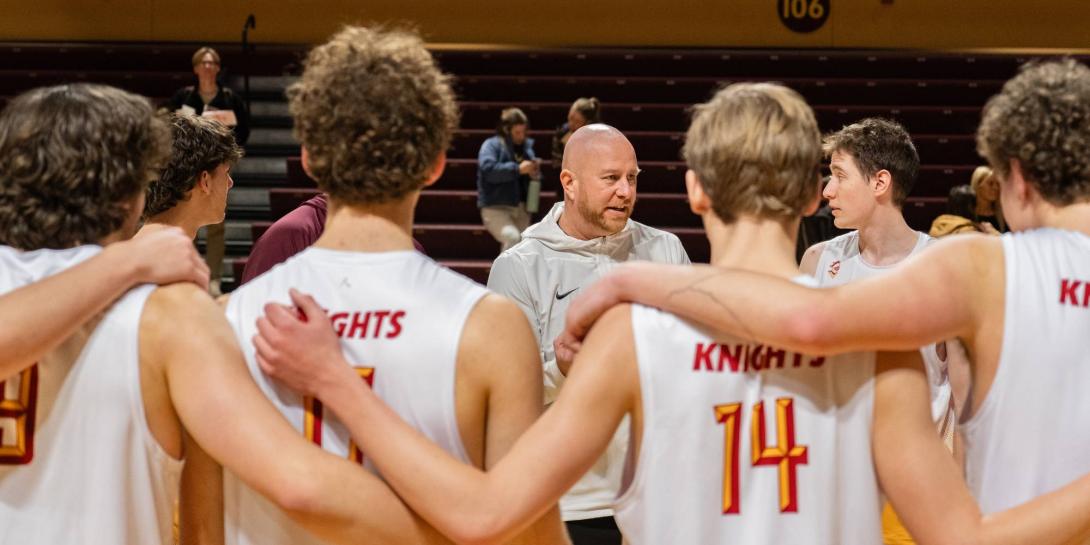 Calvin men's volleyball team listens to Aaron Sagraves in team huddle