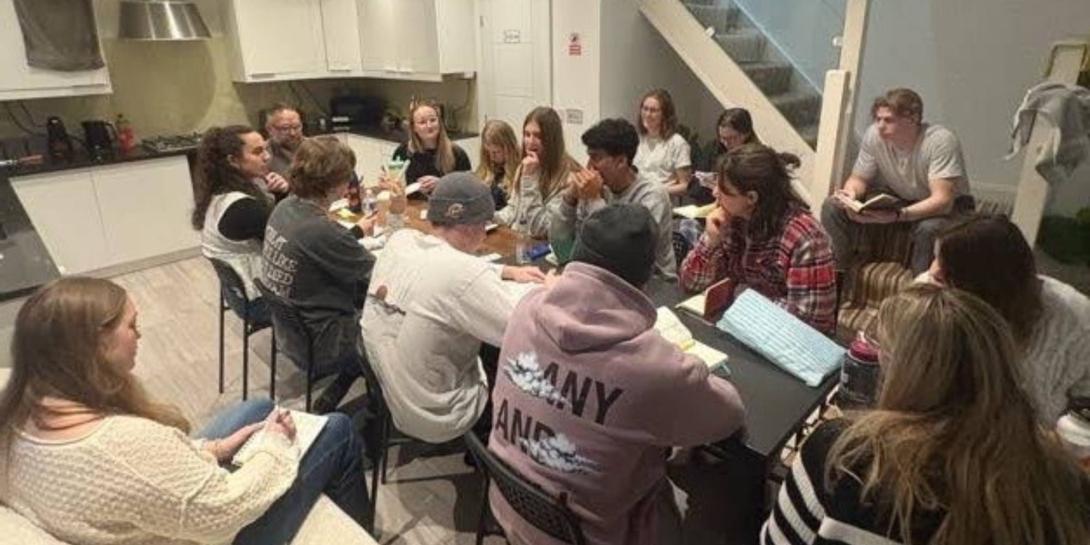 Calvin University students around a table in London.