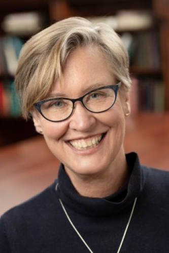 Nancy Jacobs in a black turtleneck sweater smiling