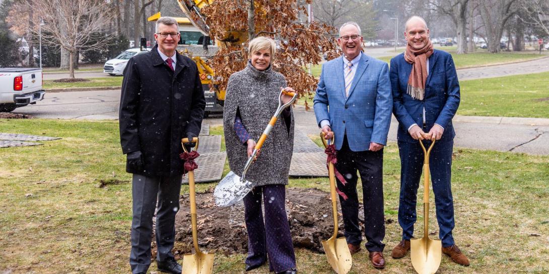 Princess Laurentien of the Netherlands on Calvin University's campus participating in the planting of a tree in her honor.