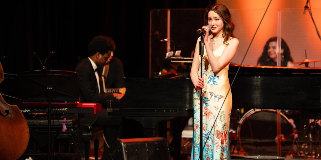 Chantale Van Tassel sings a solo on stage.