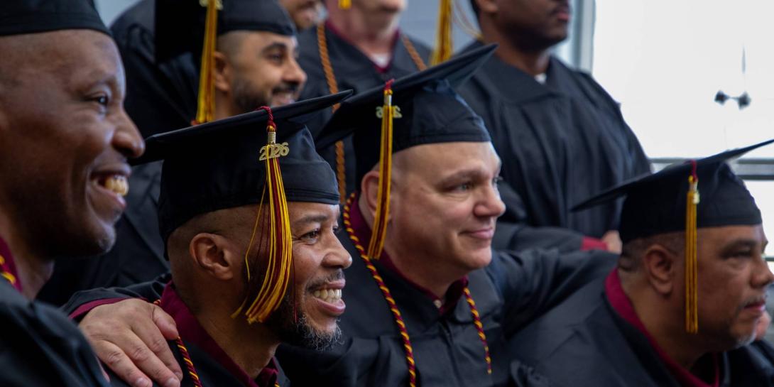 Graduates of the Calvin Prison Initiative arm in arm