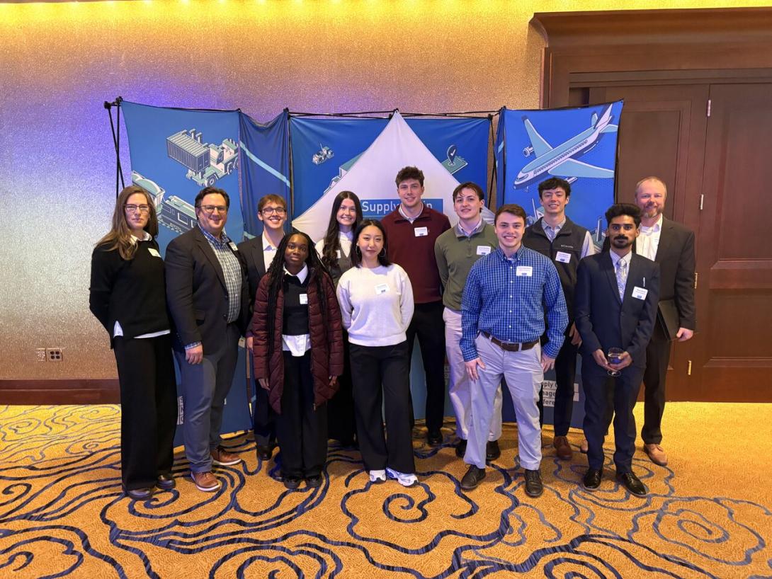 David Terpstra and a group of students post for a photo at a conference