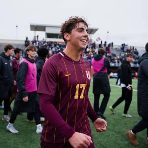Matthew Torrell smiles as he walks off the field in Calvin Knights soccer gear