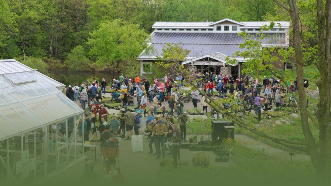 header pic looking over glass house through plaza on native plant sale morning