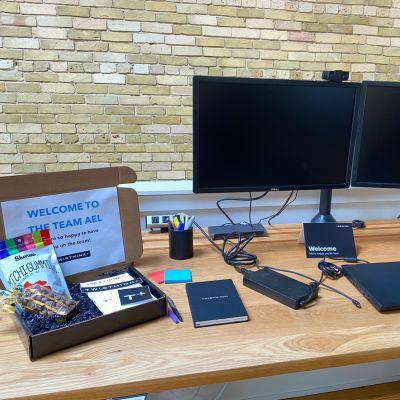 A computer with a "welcome to the team Ael" sign