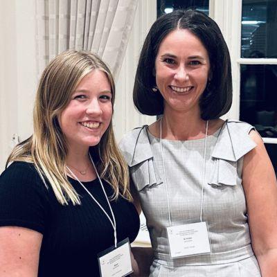 Anna Haverdink standing at a conference with Professor Kristine Johnson