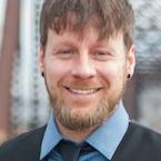 Bearded man in suit smiling