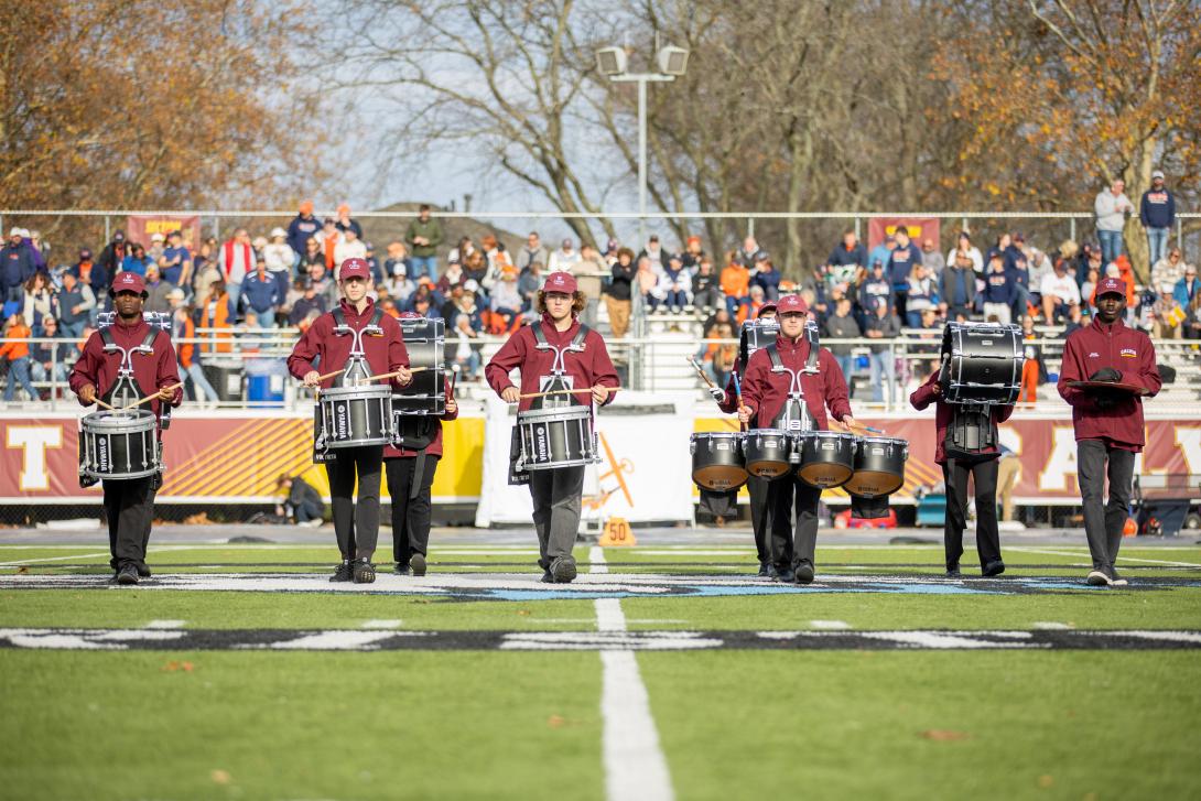 Drumline of Calvin Marching Band on Football Field.