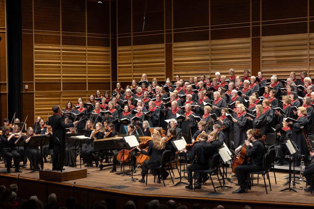 Full choir and orchestra on stage.
