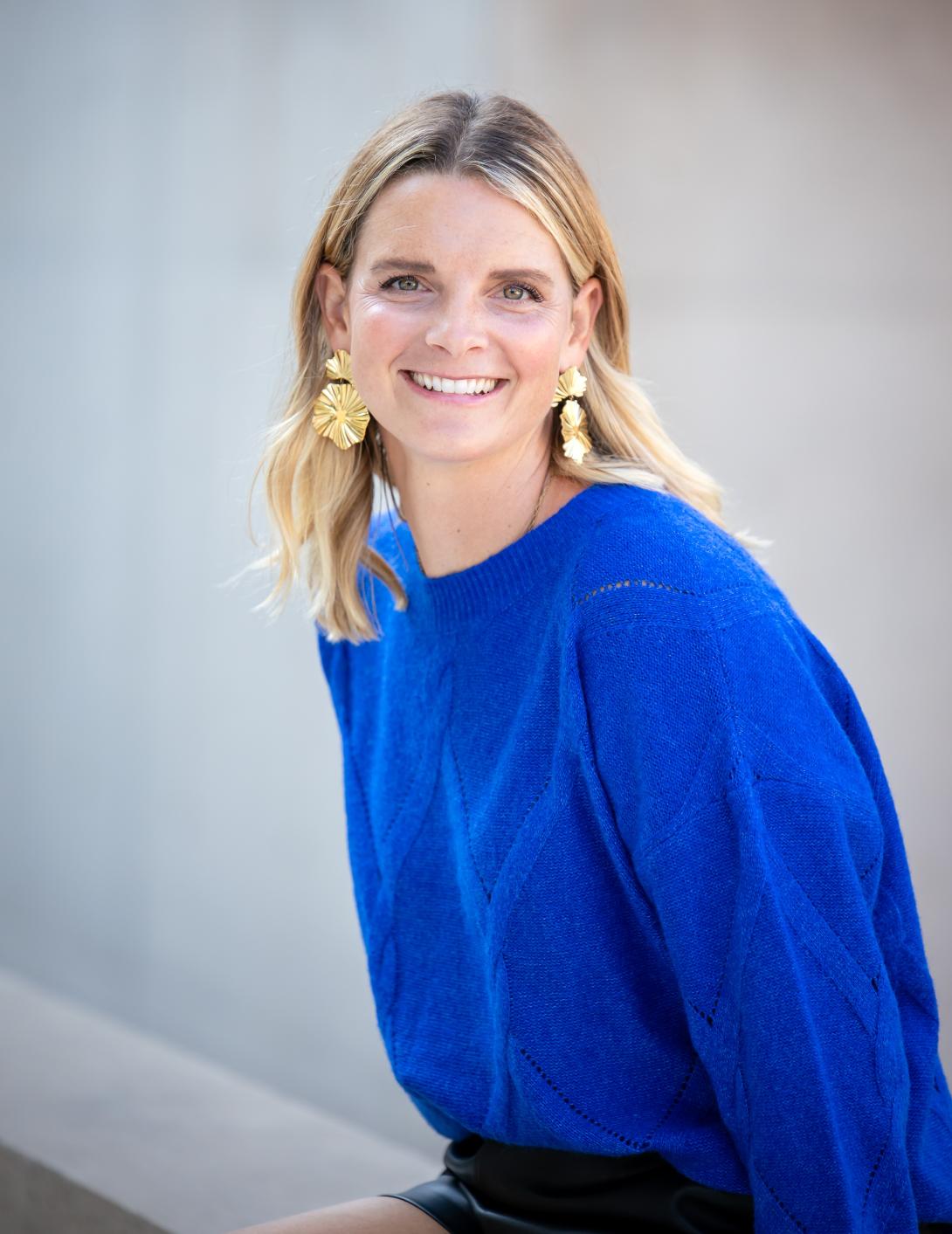becky bagnall in a blue shirt white background headshot photo
