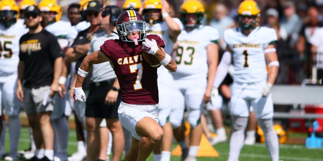 A running back running down the field for Calvin University's football team