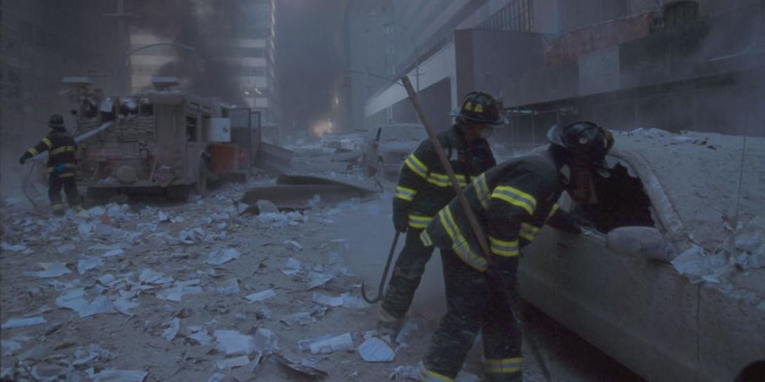 Firefighters searching cars following the Sept. 11, 2001 terrorist attack