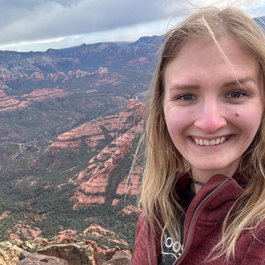 Olivia Kutsche smiling headshot with Grand Canyon in background