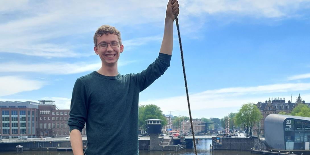 Student poses with city in the background