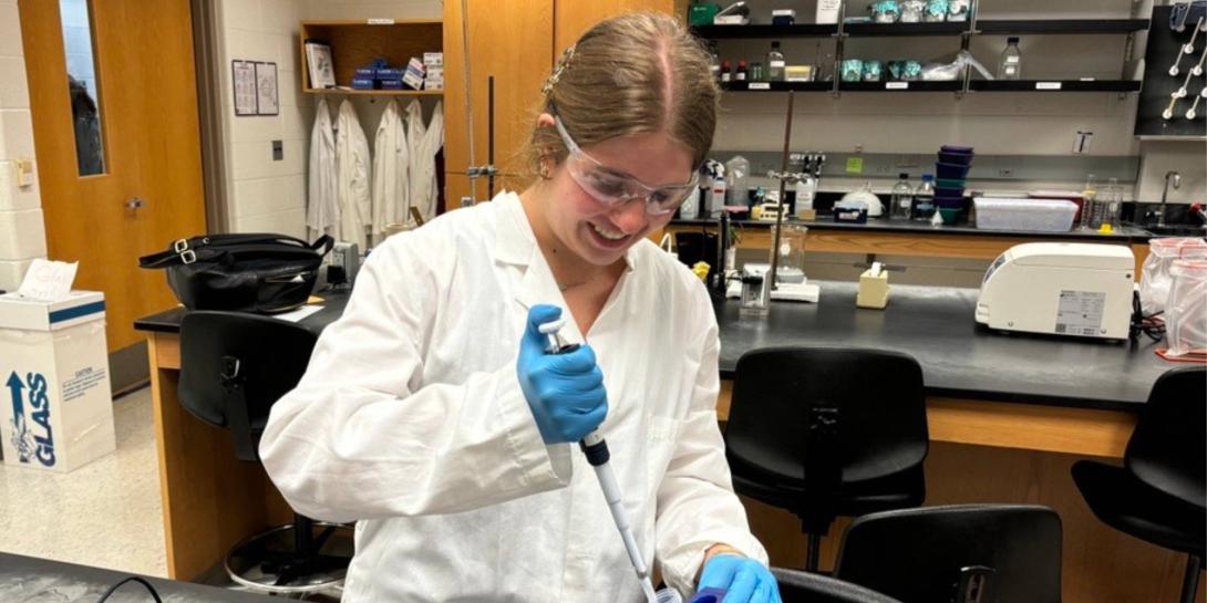 Hannah King wearing a lab coat in a chemistry lab.