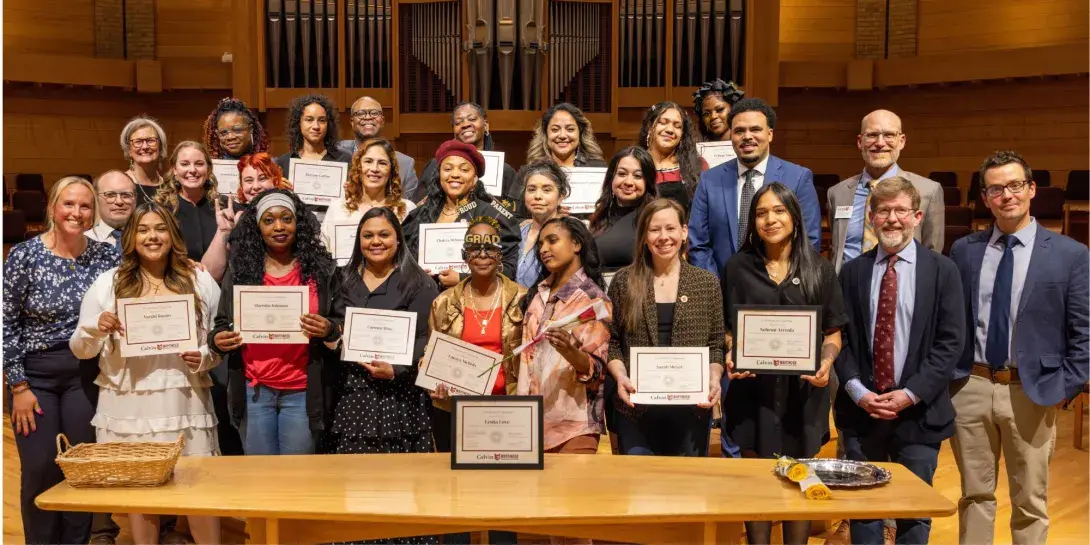 The Wayfinder Class of 2025 standing with professors and administrators of the program during their graduation ceremony.