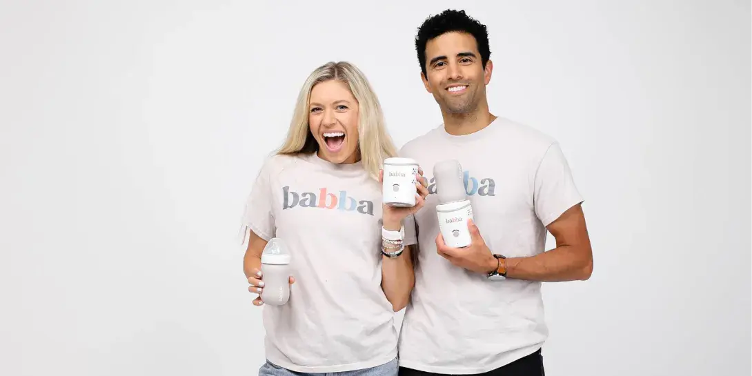 Dan Evans and his wife holding the Babba baby cooler and warmer.