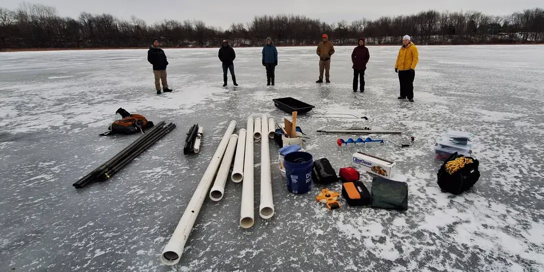 Calvin students and faculty doing research at Flat Iron Lake in winter.